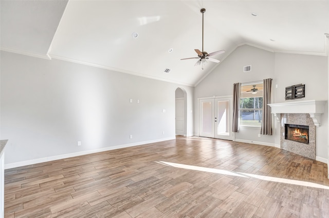 unfurnished living room featuring ceiling fan, high vaulted ceiling, light hardwood / wood-style floors, and ornamental molding