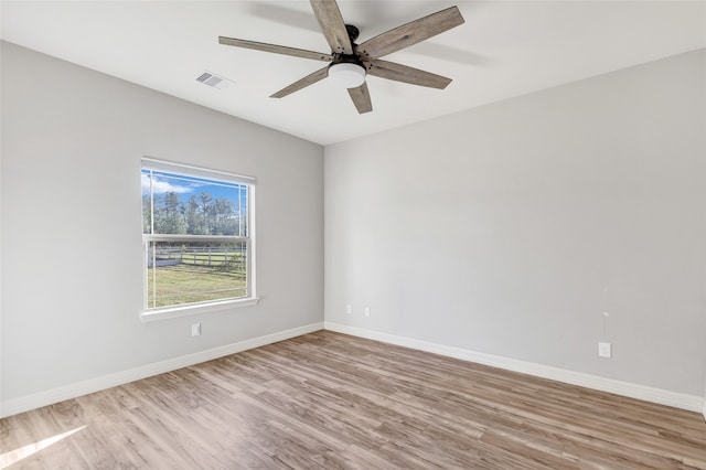 spare room with light wood-type flooring and ceiling fan