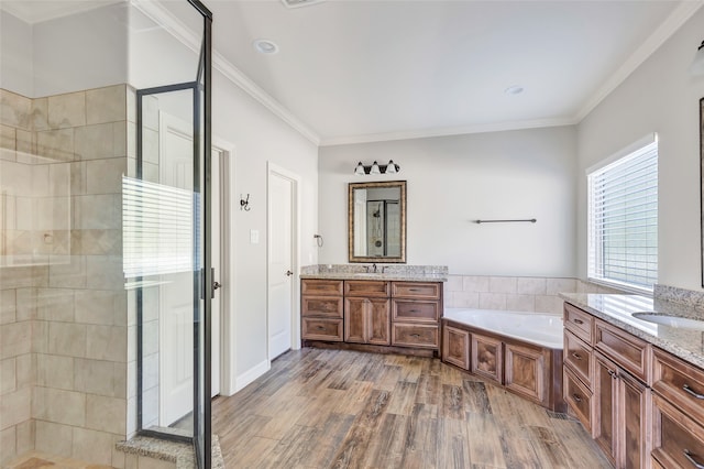 bathroom featuring hardwood / wood-style floors, vanity, separate shower and tub, and crown molding