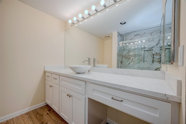 bathroom featuring wood-type flooring, vanity, and a shower with door