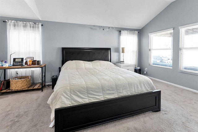 carpeted bedroom with lofted ceiling