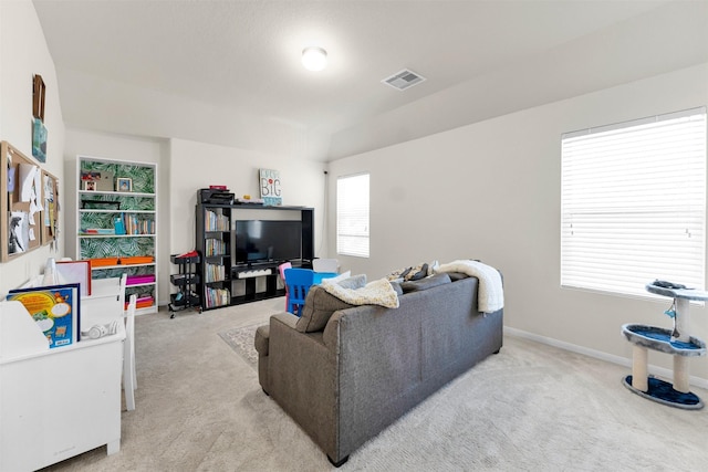 living room featuring a wealth of natural light and light carpet