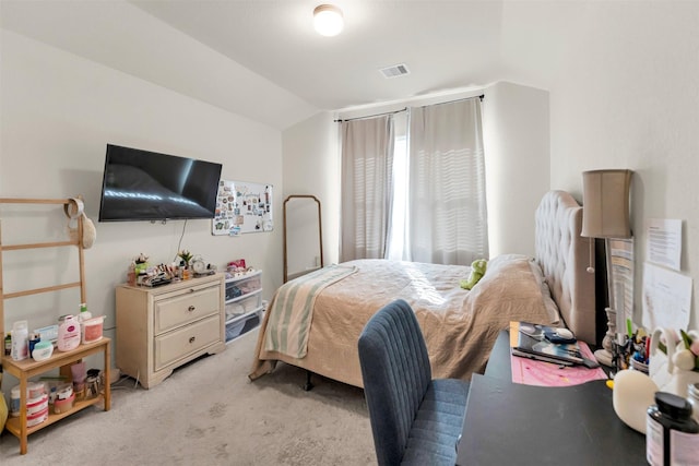 bedroom featuring light colored carpet and lofted ceiling