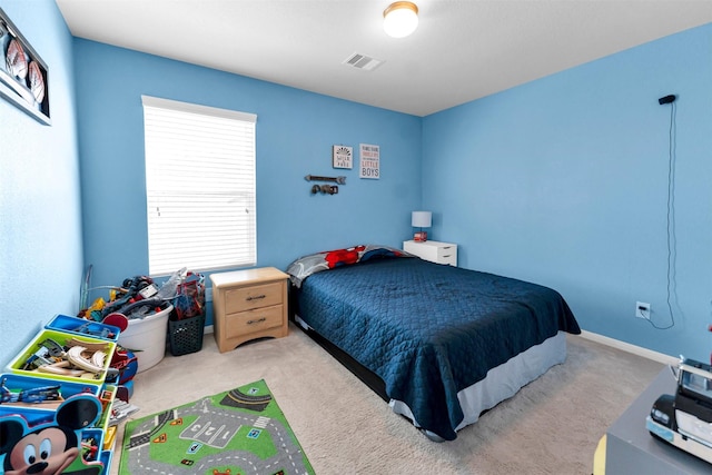 bedroom featuring light colored carpet