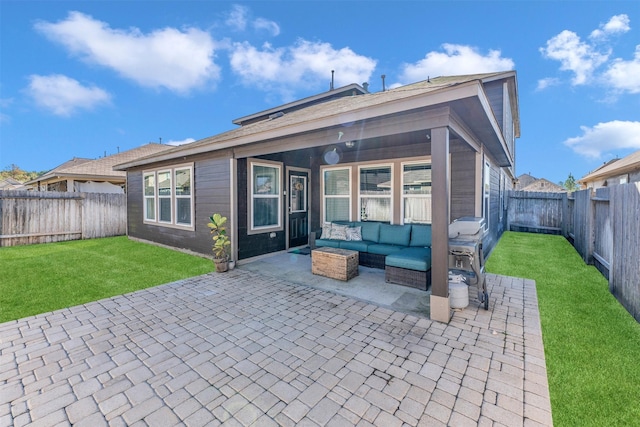 back of house with a yard, outdoor lounge area, and a patio area