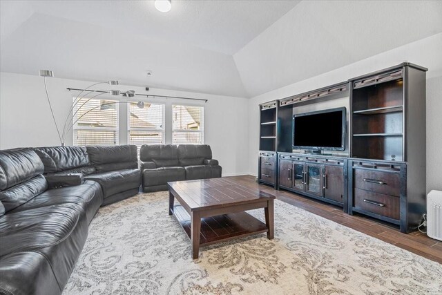 living room with hardwood / wood-style flooring and vaulted ceiling