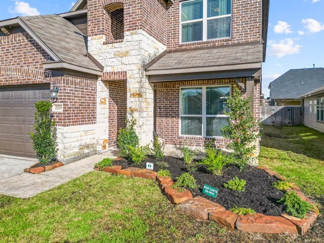 view of front facade with a garage and a front yard