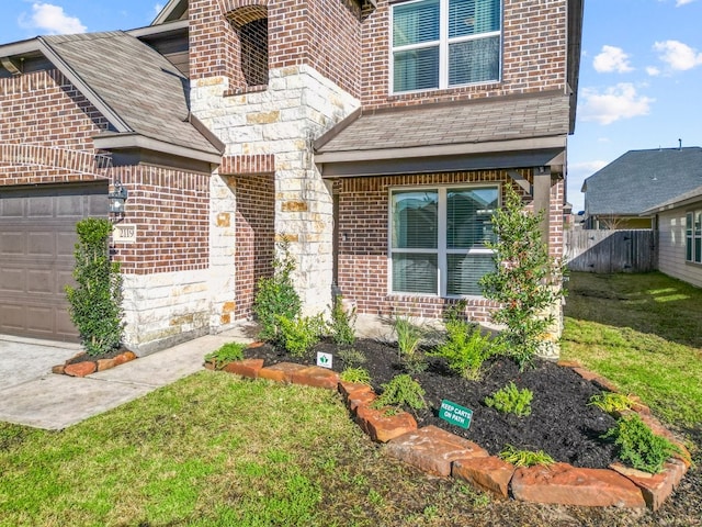 doorway to property featuring a garage and a yard