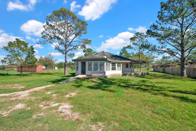 back of property featuring a yard