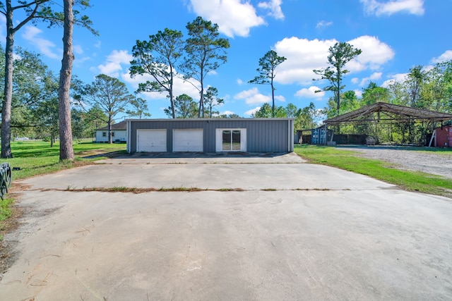 garage with a carport and a yard