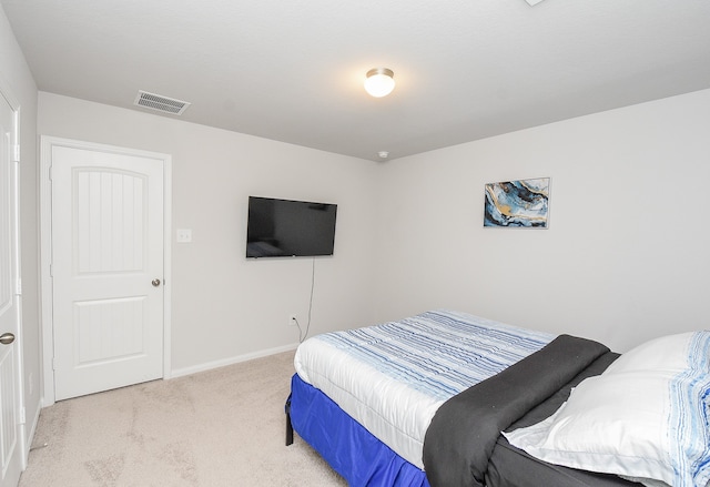 bedroom with light colored carpet