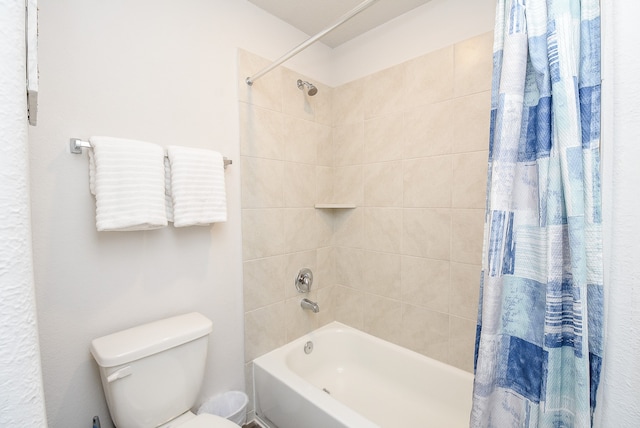 bathroom featuring shower / bath combo with shower curtain and toilet