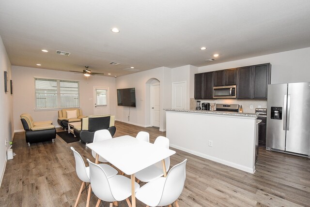 dining area with light hardwood / wood-style floors and ceiling fan