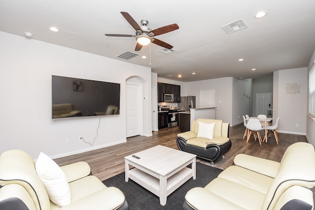 living room with ceiling fan and wood-type flooring