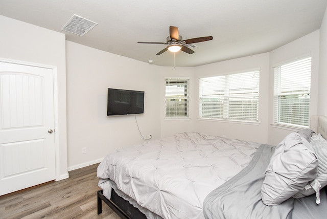 bedroom with hardwood / wood-style floors and ceiling fan