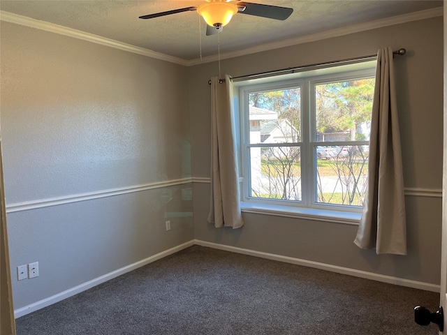 carpeted empty room with ceiling fan, plenty of natural light, and crown molding