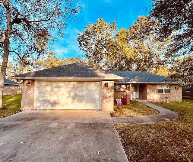 ranch-style home with a garage and a front yard