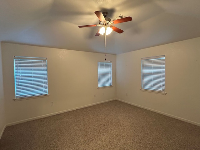 spare room with carpet, ceiling fan, and vaulted ceiling