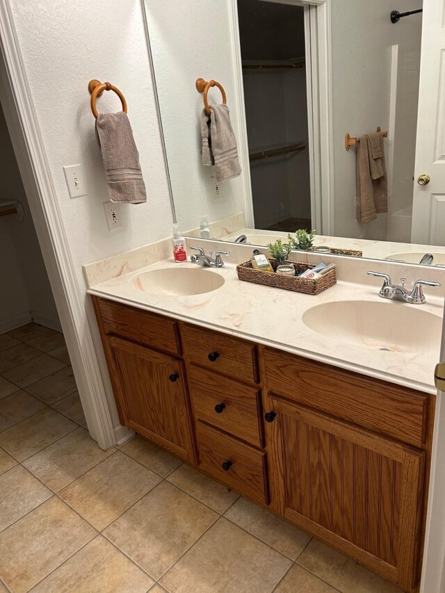 bathroom with tile patterned flooring and vanity