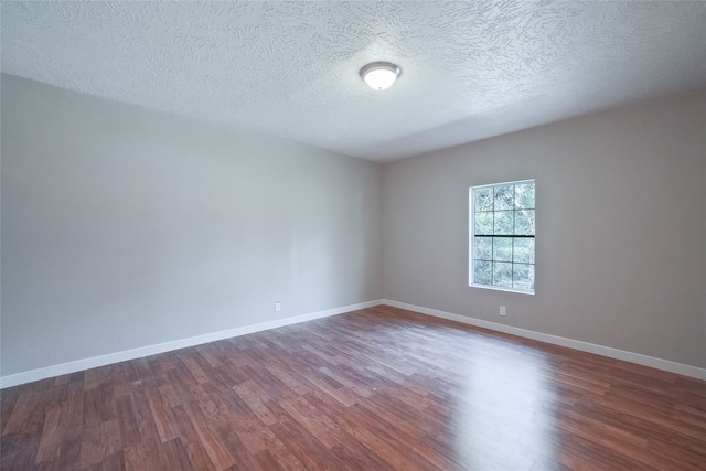 spare room with wood-type flooring and a textured ceiling