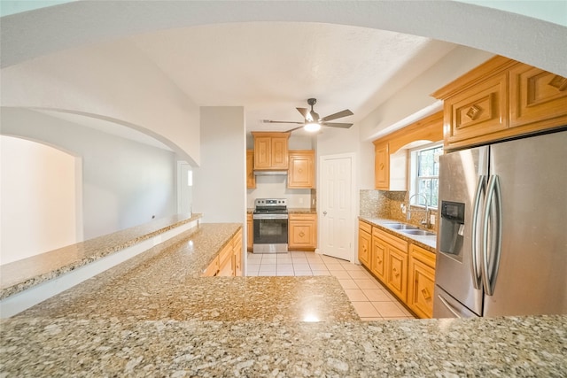 kitchen featuring sink, vaulted ceiling, ceiling fan, appliances with stainless steel finishes, and light tile patterned flooring