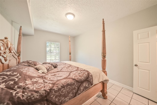 bedroom with light tile patterned floors and a textured ceiling