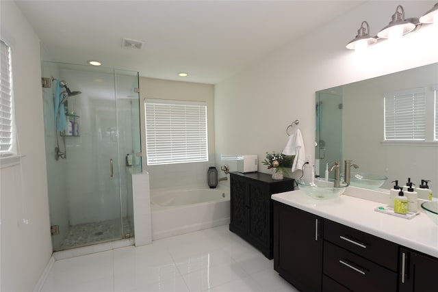 bathroom featuring tile patterned flooring, vanity, and independent shower and bath