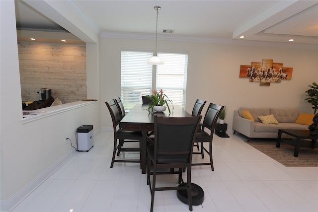 dining room featuring ornamental molding and light tile patterned floors