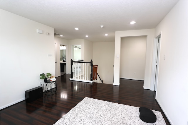 hallway featuring a textured ceiling and dark hardwood / wood-style floors