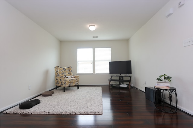 sitting room with dark hardwood / wood-style flooring