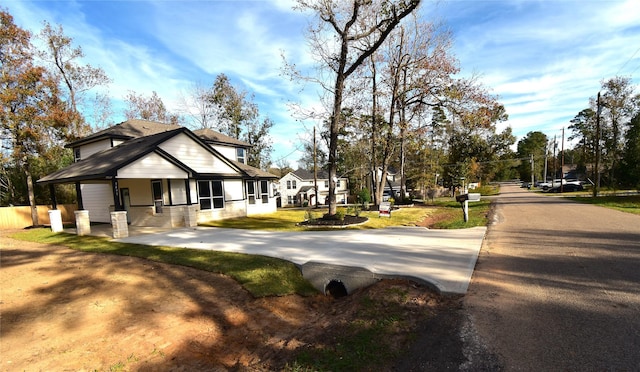 view of side of property with covered porch