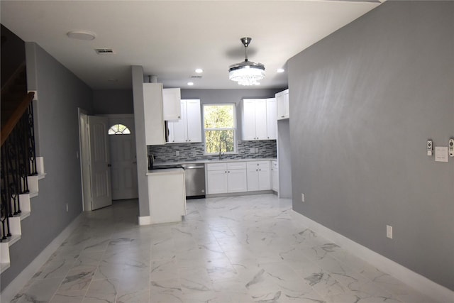 kitchen featuring dishwasher, backsplash, white cabinets, sink, and hanging light fixtures