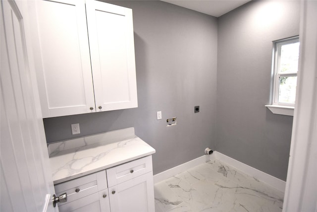 laundry area with washer hookup, electric dryer hookup, and cabinets