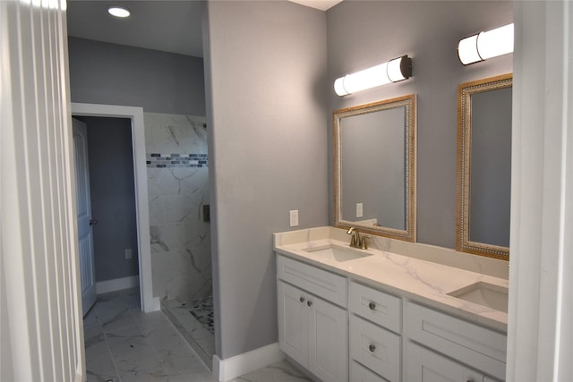 bathroom with vanity and a tile shower