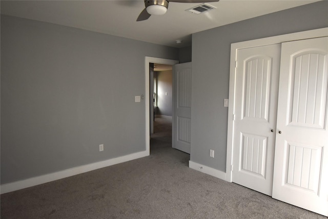 unfurnished bedroom featuring ceiling fan, a closet, and light colored carpet