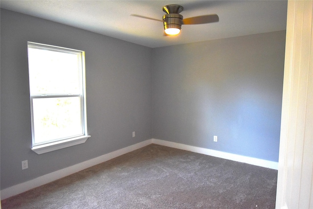 carpeted spare room featuring plenty of natural light and ceiling fan