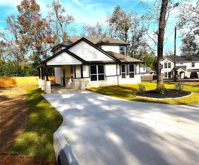 view of front of house with a front yard and a carport