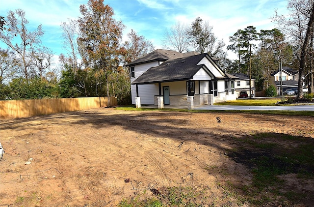 view of side of home with covered porch