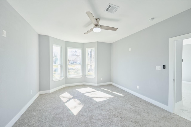 carpeted spare room with ceiling fan