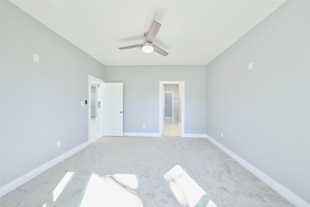 unfurnished bedroom featuring ceiling fan, light colored carpet, and ensuite bathroom