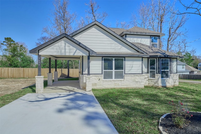 view of front facade with a carport and a front yard