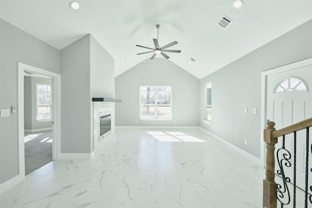 living room featuring ceiling fan, lofted ceiling, and a premium fireplace