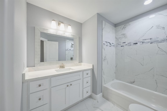 full bathroom with vanity, tiled shower / bath combo, and toilet