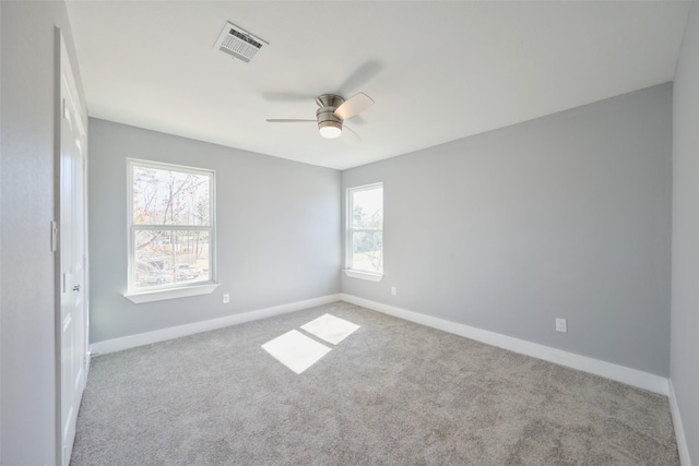 carpeted spare room with ceiling fan