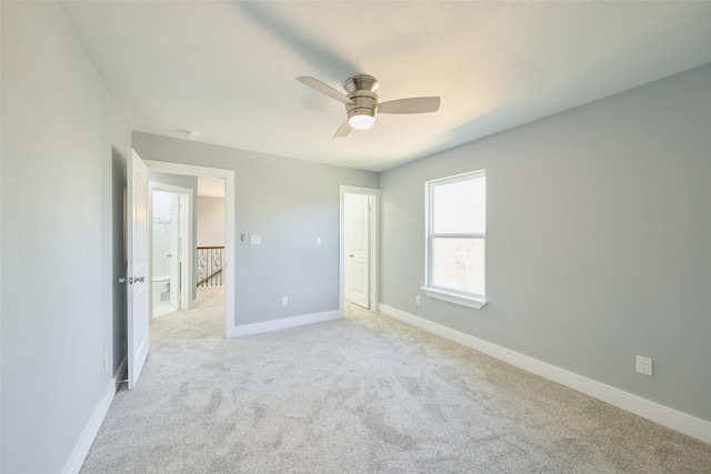 unfurnished bedroom featuring light carpet and ceiling fan