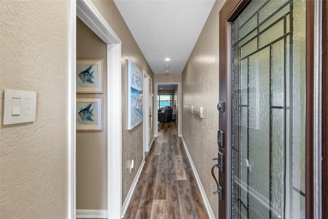 hallway with hardwood / wood-style flooring