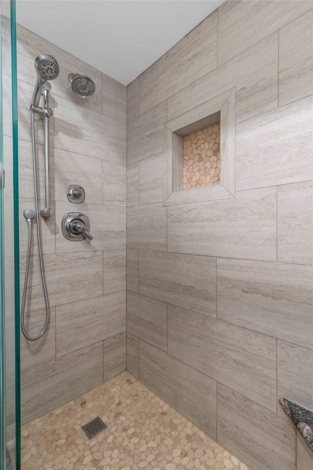 bathroom with a tile shower