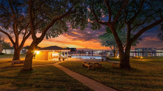 view of community with a yard and a water view