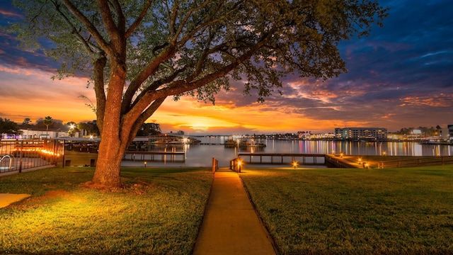 view of dock featuring a yard and a water view