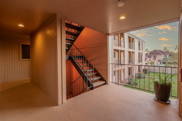 interior space with a wall of windows and wood walls